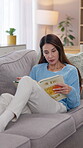 Mature woman, relax and reading book on sofa for literature hobby, and fiction story in living room. Home, comfortable and female person with novel on weekend for fantasy, learning and knowledge