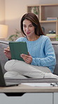 Woman, tablet and relax on couch with research, scroll and internet for digital app and connection. Girl, home and break on sofa with social media, communication and networking in home lounge