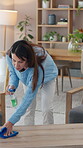 Woman, cleaning service and hygiene for housekeeping, germs or disinfectant in home or lounge. Female person, housewife, spray cleaner and dirt for dust, bacteria or product on table surface in house