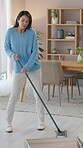 Happy woman, dancing and cleaning with broom, energy and playful in home on weekend for housekeeping. Female person, joyful and entertainment for relax, break and having fun in living room for chores