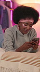 Girl, under eye patches and phone on bed in home for social media scroll, watching online videos or night skincare. Gen z, black person or smile with smartphone in bedroom for streaming subscription