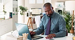 Black man, typing and laptop with paperwork for report, finance or accounting at office desk. African, businessman or accountant with computer or documents for audit, financial planning or budget