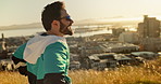 Music, fitness and man in city in morning with earphones for exercise, training and cardio workout in town. Sports, happy and person listening to audio, podcast and radio for running with view