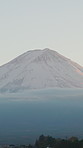 Japan, mountains and nature with volcano, hill and outdoor with landscape and Mount Fuji. Snow, mist and clouds with blue sky, forest and winter with morning, location and tourist attraction