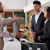 Man, concierge and problem with argument, mistake and drama in hotel ...
