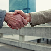 Bridge, business and man with handshake for meeting, partnership and ...