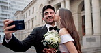 Couple, kiss and selfie for wedding, marriage and love together with fun, joy and commitment in city. Bride, groom and people outdoor for social media, excited or profile picture with romantic memory