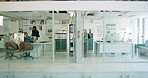 Glass, walking and business people in office with documents for meeting, consulting and talking. Corporate, modern building and workers with paperwork for planning, discussion and collaboration