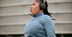 Fitness, cardio and headphones with woman and skipping rope in city for workout, streaming podcast or challenge. Health, energy and exercise performance with person jumping in urban town for wellness