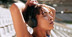 Woman, runner or relax with headphones at stadium for race, sprint or workout preparation. Young, female person or calm athlete with music for breathing exercise, training or getting ready in fitness
