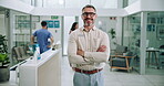 Mature, business man and arms crossed at clinic for leadership in healthcare admin or patient care. Hospital director, employer and portrait with smile in medical center for compliance and management