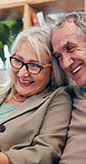 Happy, sofa and senior couple in home for relaxing, bonding and watching online videos together. Retirement, marriage and mature man and woman with tech laughing for funny joke, humor and chatting