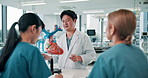 Japanese doctor, medical students and education in hospital or clinic as cardiology or anatomy class. Man, women and teaching with heart model in classroom as professor, mentor or expert cardiologist