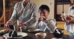 Japanese family, home and child at dinner for food, happiness and bonding together for healthy meal. People, kid and hungry for eating dumplings, diet and nutrition in dining room at table with care