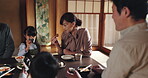 Japanese family, home and children at lunch for food, happiness and bonding together for healthy meal. People, kids and hungry for eating rice, diet and nutrition at dining room table with chopsticks