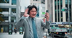 Japanese businessman, waving and video call in city with smartphone, mobile app and greeting to contact. Urban, male realtor and hello with headphones for listening, networking and talking in Tokyo