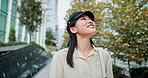 Japanese woman, happiness and city street for sightseeing, thinking and proud with travel or tourism. Female person, buildings and confidence in town for adventure, experience and location as tourist
