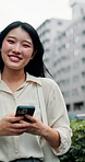 Japanese woman, face and smartphone in town for communication, networking or social media on street. Girl, portrait and phone for online browsing, typing or chatting for urban city travel post
