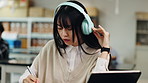 Tablet, university and headphones of woman with phd, study and thesis notes with app video. Study, writing and webinar with information for graduate and Japanese student research for elearning