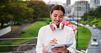Bridge, city and tablet with business woman outdoor for creative web development as graphic designer. Pen, smile and street with Japanese employee in urban town for deadline as editor or publisher