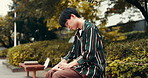 Outdoor, asian man and smile with diary for writing, daily reflection and wellness peace in park. Japanese person, male writer and ideas with notebook for holiday experience, journal or mental health