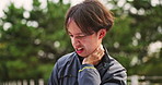 Fitness, injury and neck pain with Japanese man in park for running, training or workout routine. Accident, cardio or exercise and sports athlete rubbing muscle in physical discomfort for emergency