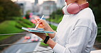 City, hands and tablet with business person on bridge in city of Japan for graphic design or web development. Creative, headphones and pen with editing or publishing employee outdoor for media job
