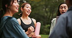 Fitness, group and talking with woman friends outdoors in park together for start of exercise routine. Conversation, planning and smile with Japanese people in nature for training or workout progress