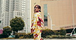 Woman, thinking and walking in city of Japan, traditional kimono and outdoor to ponder town. Female person, commute and reflection on asian heritage or culture, street journey and urban inspiration