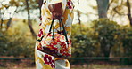 Hands, woman and bag in traditional dress with walking to cultural ceremony or event in Japan. Outdoor, female person and park in kimono clothes for fashion, style and heritage fabric in confidence