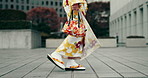 Walking, person and feet with kimono for Japanese fashion, culture clothes and heritage style. Woman, legs and traditional outfit with floral dress for travel, journey and adventure in city of Tokyo