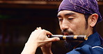 Japanese man, flute and playing for culture, music and zen with meditation, Buddhist and sound. Asian person, bamboo and instrument for tradition, performance and spiritual heritage with shakuhachi