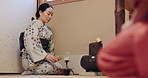 Woman, tea ceremony and bowl with matcha mix for process at Japanese tradition with culture, service and tools. Powder, ceramic and ground for traditional detox, health and green drink custom