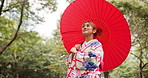 Kimono, nature and woman with umbrella, park and travel for fresh air, exploring and calm for culture. Spring, scenery and clothes in forest, traditional and outdoor with smile and person in Japan