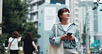 Japan, walking and city girl with cellphone, internet and connection with email notification. Asian woman, outdoor and person with smartphone, travel and urban town with online reading and tourism