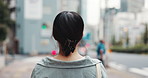 Woman, travel and back in city for walk, direction and outdoor with vacation on urban street. Person, tourist and holiday by skyscraper, buildings and view with commute on metro sidewalk in Japan