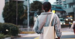 Girl, travel and back in city for walk, direction and outdoor with vacation, journey and urban street at night. Woman, tourist and holiday with bag, location and metro crosswalk with commute in Japan