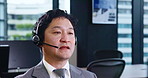 Asian man, consultant and call center with headphones for customer service or telemarketing at office. Japanese, male person or agent with headset for telecommunications, online advice or assistance