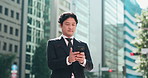 Business man, smartphone and texting in street, thinking and reading for negotiation, deal or chat in city. Person, phone and scroll with mobile app, notification or networking on urban road in Japan
