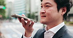 Business man, speakerphone and talk in city, thinking and contact for negotiation, deal and chat in street. Person, phone and voice notes with mobile app, reminder and travel on urban road in Japan