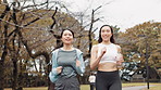 Japanese, running and women in park, training and morning routine with energy. Healthy people, friends and runners with cardio or workout with fitness, exercise or practice with wellness or challenge