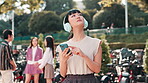 Asian woman, headphones and phone for direction in city, lost and online for map navigation in Japan. Female person, urban route and streaming podcast for travel guidance, journey and town adventure