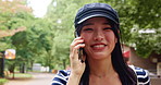 Japanese woman, park and talking with phone call for communication, walking and listening to contact. Nature, female person and happy with mobile for conversation, journey update and travel outdoor