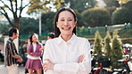 Arms crossed, face and leadership with Japanese woman outdoor for confidence or pride in work. Happy, portrait and smile of business employee in nature park for corporate team building event