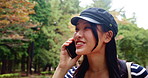Japanese woman, park and communication with phone call for talking, walking and listening to contact. Nature, female person and happy with mobile for conversation, adventure update and travel outdoor