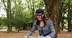 Cycling, bike and smile with Japanese woman in park for travel, carbon footprint and health. Eco friendly, transportation and summer with asian person and bicycle in nature for happiness and wellness