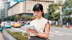 Tablet, developer or Asian woman in city for street, research or real estate agent by office buildings. Road, businesswoman or realtor on app for online listing, travel or urban development in Japan