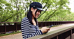 Happy, Japanese woman and phone outdoor for communication, reading notification and social media. Girl, smile and typing on mobile with contact, texting chat and networking for nature travel in Japan