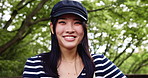 Face, hat and Japanese woman in park, smile and confidence with trees, wellness and calm. Portrait, Asian person and girl with stylish clothes, summer holiday and pride with happiness and outdoor