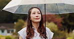 Thinking, umbrella and Asian woman in park with rain for commute, journey and travel outdoors. Nature, winter and Japanese person walking with protection for drops, splash and water in cold weather